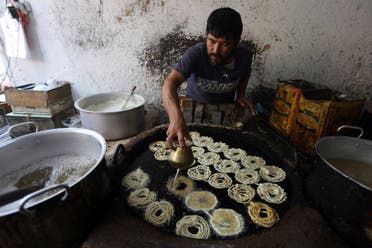 A man make traditional sweets at a market ahead of the upcoming Eid al-Adha holiday in the old section of Kabul, Afghanistan, Thursday, Aug. 31, 2017. (AP)