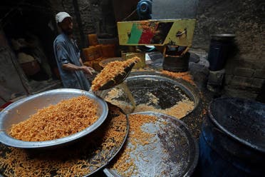 An Afghan man makes traditional sweets at a market ahead of the upcoming Eid al-Adha holiday in the old part of Kabul, Afghanistan, Thursday, Aug. 31, 2017. (AP)