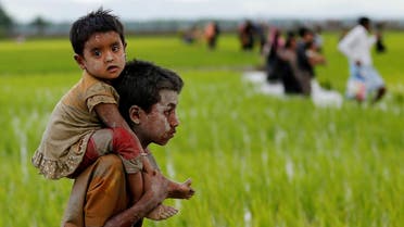 A Rohingya boy carries a child after after crossing the Bangladesh-Myanmar border in Teknaf, Bangladesh, September 1, 2017. REUTERS/Mohammad Ponir Hossain