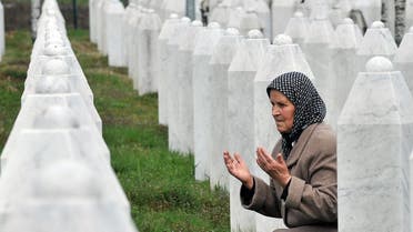 Bida Smajlovic, 64, a survivor of July 1995 massacre in Srebrenica prays by her husband's grave at a memorial center in Potocari, on March 24, 2016. AFP