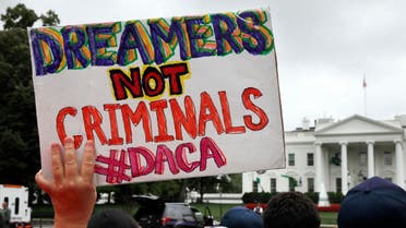 a woman holds up a signs in support of the Obama administration DACA program, during an immigration reform rally at the White House in Washington. (AP)