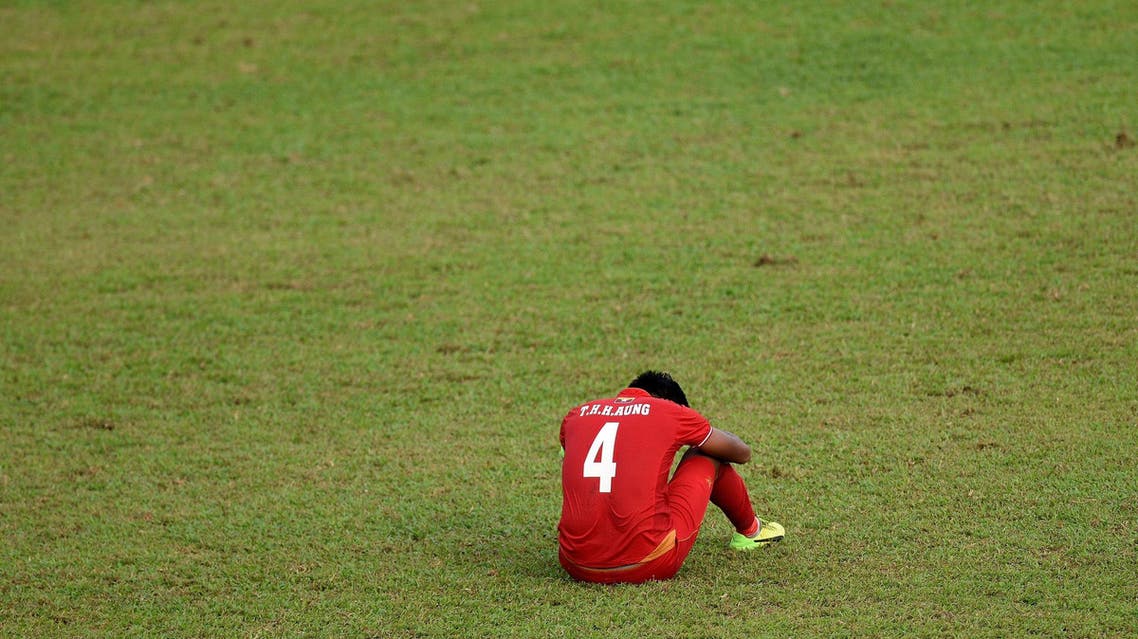 Myanmar's Thiha Htet Aung(R) sits dejected on the field after losing to Thailand during their men's football semi-final match of the 29th Southeast Asian Games (SEA Games) at Selayang Stadium, outside Kuala Lumpur on August 26, 2017. AFP