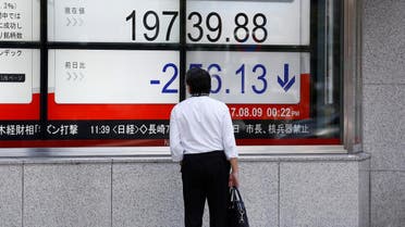 A man looks at an electronic board showing Japan’s Nikkei average outside a brokerage at a business district in Tokyo, Japan August 9, 2017. (Reuters)