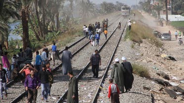 Egyptians block the tracks in protest as they gather at the site of a train crash that killed at least 51 people, most of them children between 4 and 6 years old, near Assiut in southern Egypt, in Cairo, Egypt, Sunday, Nov. 18, 2012. AP
