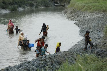 Displaced Rohingya refugees from Rakhine state in Myanmar cross a river near Ukhia, near the border between Bangladesh and Myanmar, as they flee violence on September 4, 2017. AFP