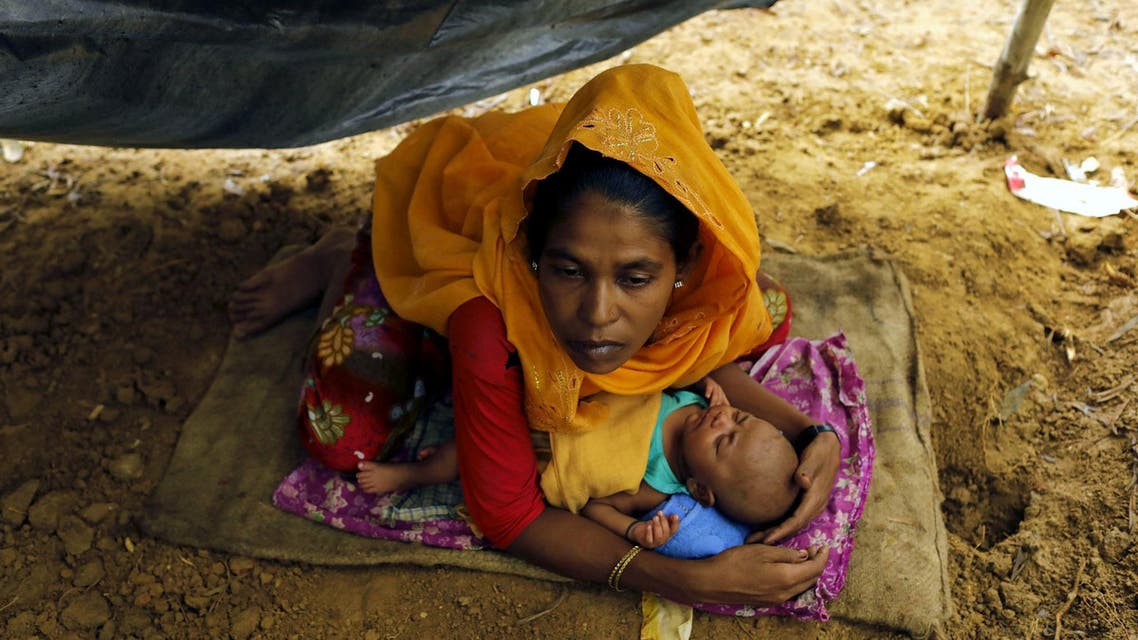 Rohingya refugees from Myanmar's Rakhine state shelter in a makeshift tent after arriving at a refugee camp near the Bangladeshi town of Teknaf on September 5, 2017.