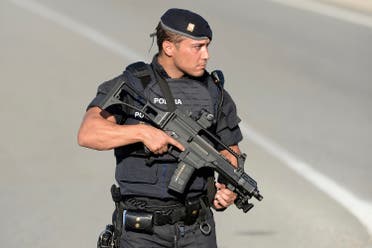 An armed Spanish policeman stands guard at the site where Moroccan suspect Younes Abouyaaqoub was shot on August 21, 2017 near Subirats, south of Barcelona, four days after the Barcelona and Cambrils attacks that killed 15 people. (AFP)