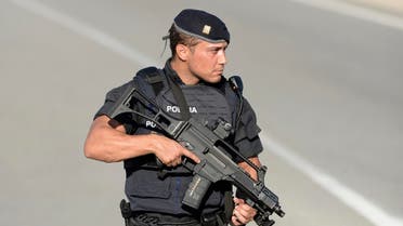 An armed Spanish policeman stands guard near Subirats, south of Barcelona, four days after the Barcelona and Cambrils attacks that killed 15 people. (AFP)