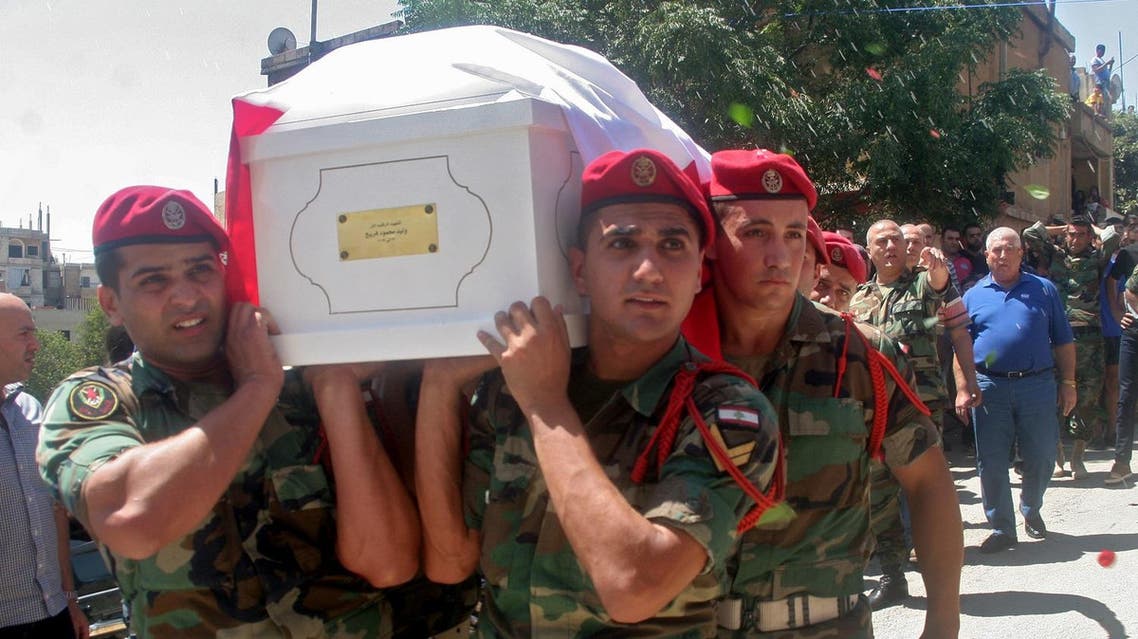 Lebanese soldiers carry the coffin of Walid Freij, a comrade who died in battles against the Islamic State (IS) group along the border with Syria, during his funeral in the town of Saadnayel in the eastern Bekaa valley on August 23, 2017. The army began its campaign in the Jurud Ras Baalbek and Jurud al-Qaa areas on Lebanon's eastern border on August 19, capturing more than two thirds of the 120 square kilometres held by IS jihadists in the first two days. (AFP)