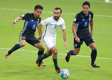Saudi Arabia's Mohammed Al Sahlawi, center, runs with the ball against Japan's Yuto Nagatomo, left, and Japan's Gen Shoji. (AP)