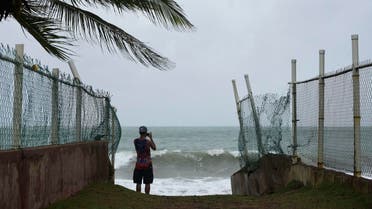 A man photographs the ocean before the arrival of Hurricane Irma, in luquillo, Puerto Rico, on Sept. 6, 2017. (AP)