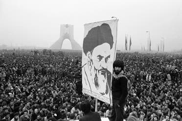 In this Dec. 10, 1978 file picture, demonstrators hold up a poster of exiled Muslim leader Ayatollah Khomeini during an anti-shah demonstration in Tehran at the Shayah monument, which was built to commemorate the monarch's rule and symbol of his power. (AP)