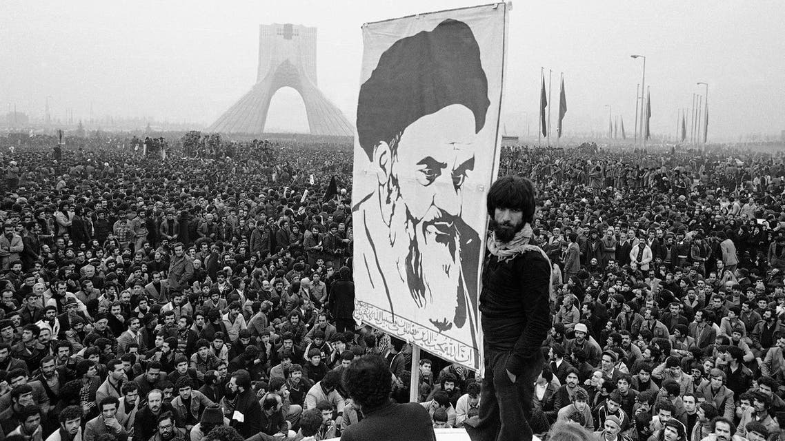 In this Dec. 10, 1978 file picture, demonstrators hold up a poster of exiled Muslim leader Ayatollah Khomeini during an anti-shah demonstration in Tehran at the Shayah monument, which was built to commemorate the monarch's rule and symbol of his power. (AP)