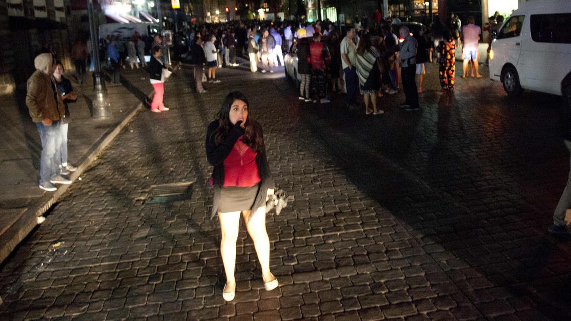 People gather on a street in downtown Mexico City during an earthquake on September 7, 2017. (AFP)