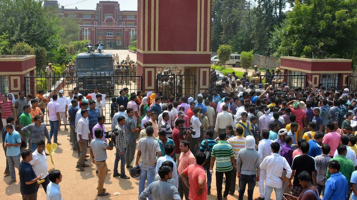 Indian security personnel and demonstrators gather outside the Ryan International School in Gurgaon on September 10, 2017. (AFP)