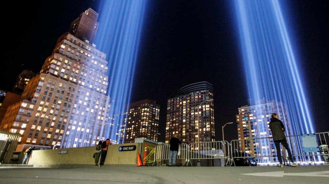 People gather on a rooftop as the ‘Tribute in Light’ illuminates the night sky, on September 10, 2017 in New York City, on the eve of the anniversary of the September 11, 2001 terror attacks. (AFP)