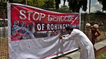 An Indian Muslim man puts his signature on a banner during a protest against the persecution of Myanmar's Rohingya Muslim minority in Hyderabad, Sunday, Sept. 10, 2017. (AP)