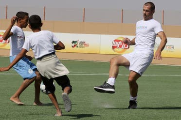 UEFA President Aleksander Ceferin (R) plays football during the opening ceremony of a football field at the Zaatari refugee camp, 80 kilometers (50 miles) north of the capital Amman, on September 12, 2017. (AFP)