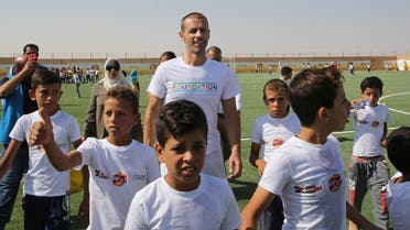 UEFA President Aleksander Ceferin (C) attends the opening ceremony of a football field at the Zaatari refugee camp, 80 kilometers (50 miles) north of the capital Amman, on September 12, 2017. (AFP)