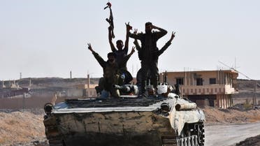 Syrian government forces celebrate in the eastern Syrian city of Deir Ezzor on September 11, 2017 as they continue to press forward with Russian air cover in the offensive against Islamic State group jihadists across the province. Syrian army reinforcements arrived in Deir Ezzor for a new push against the Islamic State group, as a second day of suspected Russian strikes killed 19 civilians in the area. (AFP)