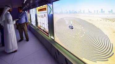 Visitors look at screens displaying images of the Mohammed bin Rashid Al-Maktoum Solar Park on March 20, 2017, at the solar plant in Dubai. (AFP)