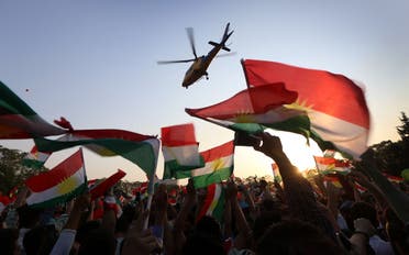 A helicopter flies over Iraqi Kurds gather to urge people to vote in the upcoming independence referendum in Arbil, the capital of the autonomous Kurdish region of northern Iraq. (AFP)