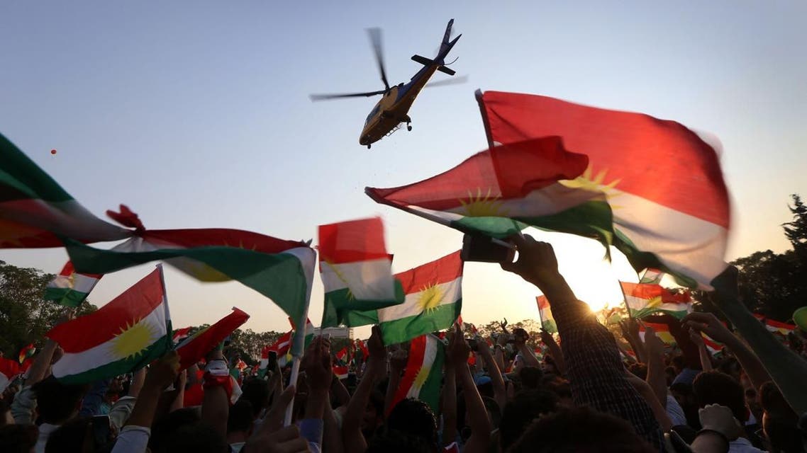 A helicopter flies over Iraqi Kurds gather to urge people to vote in the upcoming independence referendum in Arbil, the capital of the autonomous Kurdish region of northern Iraq. (AFP)