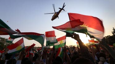 A helicopter flies over Iraqi Kurds gather to urge people to vote in the upcoming independence referendum in Arbil, the capital of the autonomous Kurdish region of northern Iraq. (AFP)