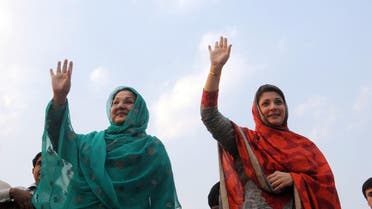 Kulsoom Nawaz (L) wife of former Pakistan's premier Nawaz Sharif wave to supporters as they take part of election campaign in Lahore on May 4, 2013. (AFP)