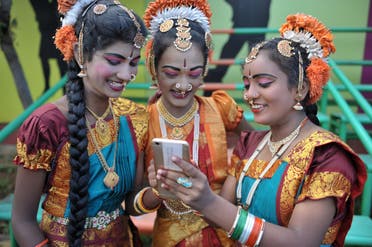 Indian girls look at a mobile phone prior to taking part during Independence Day celebrations in Secunderabad, the twin city of Hyderabad. (File photo: AFP)