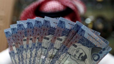 A Saudi money changer displays Saudi Riyal banknotes at a currency exchange shop in Riyadh, Saudi Arabia July 27, 2017. (Faisal Nasser, Reuters)