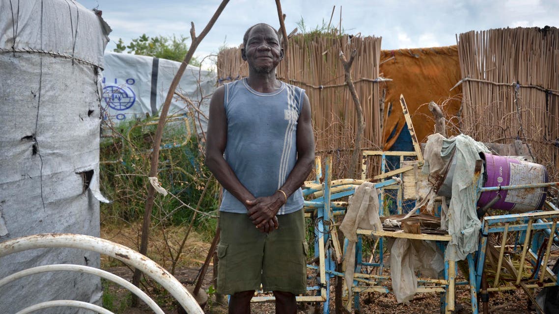 Ramadan Wani, who hasn't seen his family in the six years he has been stranded at a displaced persons' camp, stands outside his makeshift house in Payuer, South Sudan Monday, Aug. 21, 2017. (ap)