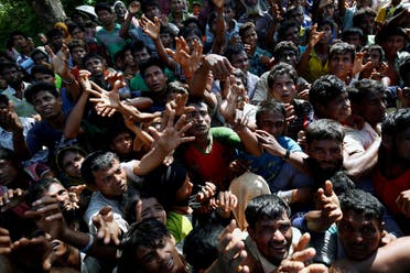Rohingya refugees stretch their hand for relief supplies given by local people in Cox’s Bazar, Bangladesh September 16, 2017. (Reuters)