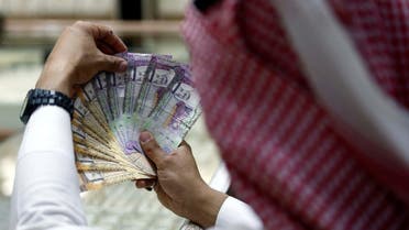A Saudi money changer displays Saudi Riyal banknotes at a currency exchange shop in Riyadh, Saudi Arabia July 27, 2017. (Reuters)