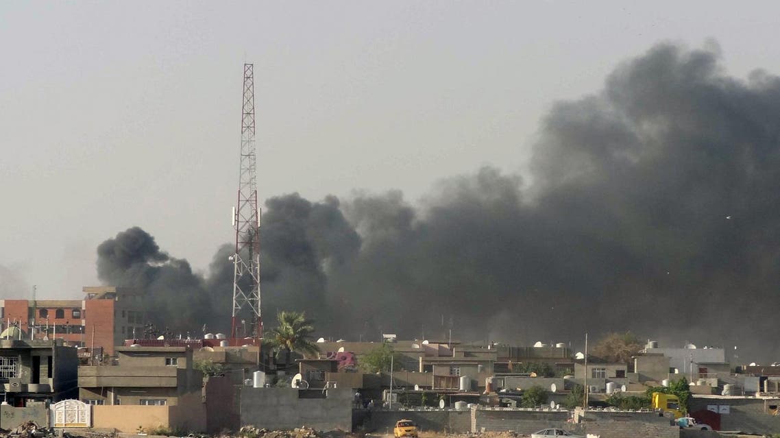 Smoke rises from buildings following a bomb attack in the Kurdish-controlled northern Iraqi city of Kirkuk on August 23, 2014. Three near-simultaneous car bombs exploded in Iraq's northern disputed city, killing over a dozen people and wounding 60, police and a doctor said. AFP PHOTO / MARWAN IBRAHIM