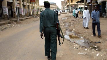 An armed policeman patrols the streets of the Sudanese capital that was largely deserted and calm 06 August 2005 as authorities declared a public holiday to allow the people to follow the funeral ceremony of First Vice President John Garang whose death in a helicopter crash triggered days of deadly riots in Khartoum. AFP