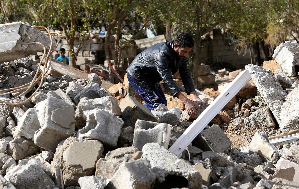 An Arab man works on rebuilding his destroyed house in Kirkuk's Huzeiran neighborhood, Iraq. (AP)