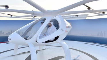 Sheikh Hamdan bin Mohammed bin Rashid al-Maktoum (C), Crown Prince of Dubai, sitting in a prototype two-seater air taxi during a "concept" flight in Dubai. (AFP)