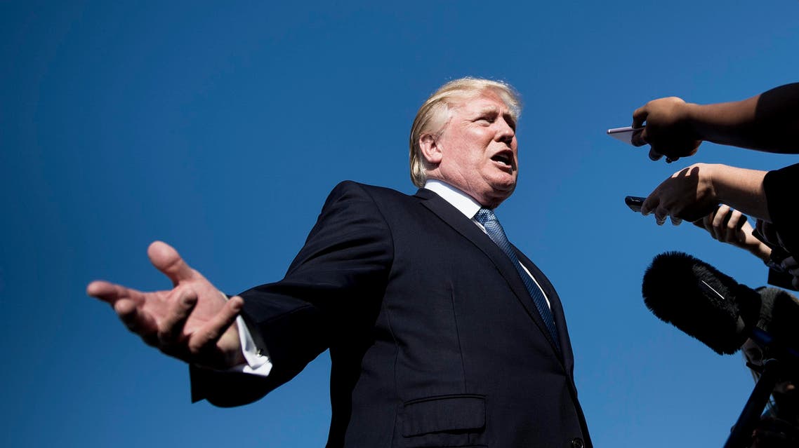 (FILES) This file photo taken on September 24, 2017 shows US President Donald Trump speaking to the press while boarding Air Force One at Morristown Airport in Morristown, New Jersey. US President Donald Trump denied stoking racial tensions on September 25, 2017, insisting his charged comments that prompted a wave of symbolic protests by NFL players were about patriotism. After his verbal attacks on black athletes led players across the country to kneel in solidarity during the US national anthem at games over the weekend, the besieged US president played defense on Twitter. Trump had sparked the furor by describing NFL players (AFP)