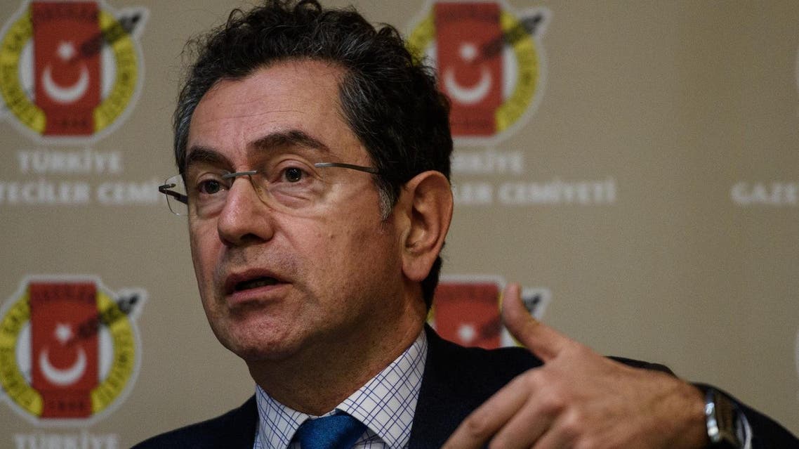 Kadri Gursel, Freedom for Jornalist Platform spokesman gestures during a press conference on December 1, 2015 in Istanbul. A court in Istanbul charged two journalists from the opposition Cumhuriyet newspaper with spying after they alleged Turkey's secret services had sent arms to Islamist rebels in Syria, Turkish media reported. (AFP)