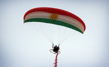 An Iraqi Kurd flies his powered parachute during the Watercraft festival on August 25, 2017, at lake Darband in Raniya district, 70 km east of Erbil. (AFP)
