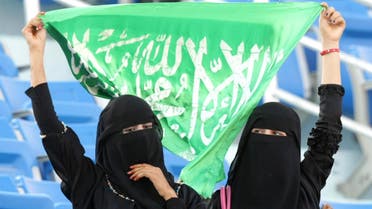 Saudi women hold up their national flag as they watch the official opening ceremony of the Gulf Cup at the 22 May Stadium in the southern city of Aden on November 22, 2010 as Yemen gets ready to host the football tournament amid tight security. AFP PHOTO/KARIM SAHIB