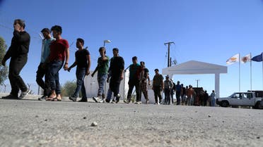 Migrants from Syria walk towards a refugee camp at Kokkinotrimithia, outside of the capital Nicosia, in the eastern Mediterranean island of Cyprus, on Sunday, Sept. 10, 2017. AP