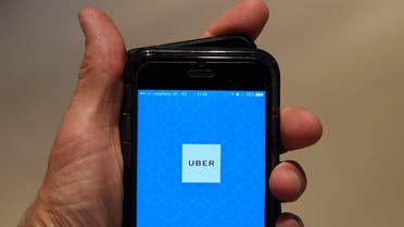 A photo illustration shows the Uber app logo displayed on a mobile telephone, as it is held up for a posed photograph in central London September 22, 2017. (Reuters)