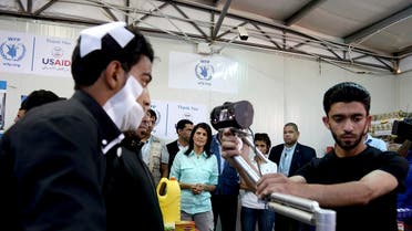 US Ambassador to the United Nations Nikki Haley looks on as a bandaged Syrian refugee has his iris scanned at a supermarket in Zaatari Refugee Camp, Jordan. (File photo: AP)