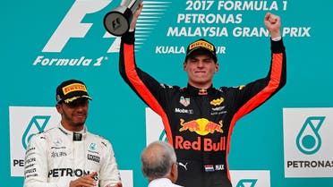 Redbull’s Max Verstappen celebrates winning the race beside Mercedes’ Lewis Hamilton and Malaysian Prime Minister Najib Razak at the Malaysia Grand Prix in Sepang on October 1, 2017. (Reuters)