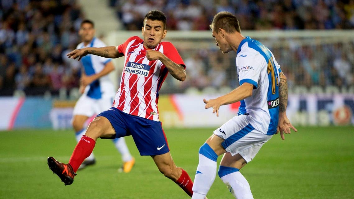 Atletico Madrid's forward from Argentina Angel Correa (L) vies with Leganes' defender from Spain Raul Garcia Carnero (R) during the Spanish league football match Club Deportivo Leganes SAD vs Club Atletico de Madrid at the Estadio Municipal Butarque in Madrid on September 30, 2017. (AFP)