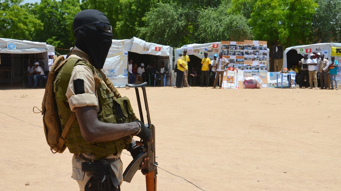 TO GO WITH AFP STORY BY BOUREIMA HAMA A Nigerian soldier stands guard near information stands in a camp for internally displaced people (IDP), home to some 300,000 Nigerian refugees and internally displaced by Boko Haram, in Diffa, Niger, on August 17, 2016, ahead of celebrations for World Humanitarian Day on August 19. BOUREIMA HAMA / AFP