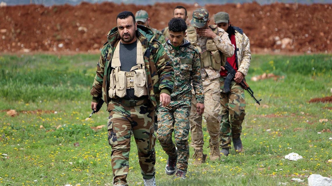 Members of the Syrian government forces march near the town of Qumhanah in the countryside of the central province of Hama, on April 1, 2017. Syrian government forces and allies regained most of the territory they lost earlier during an assault by rebels and jihadists launched on March 21, 2017 in the country's centre, reported the Britain-based Syrian Observatory for Human Rights monitor on March 31, 2017. (AFP)