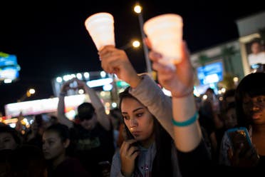Mourners attend a candlelight vigil at the corner of Sahara Avenue and Las Vegas Boulevard for the victims of Sunday night’s mass shooting, on October 2, 2017 in Las Vegas, Nevada. (AFP)